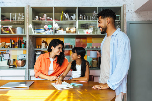 Happy family spending quality time in a cozy modern kitchen setting