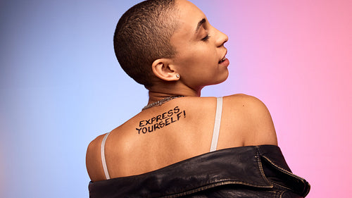 Bald female posing on colorful background