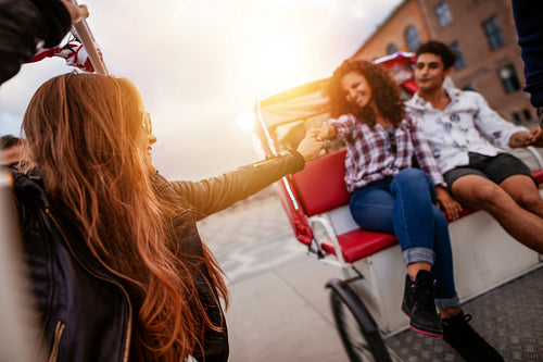 Young people enjoying tricycle ride
