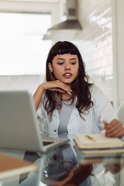 Focused businesswoman making notes while working at home