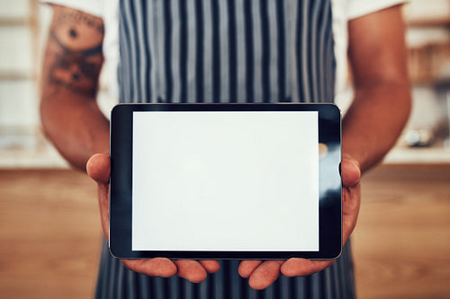 Waiter holding a digital tablet with blank screen