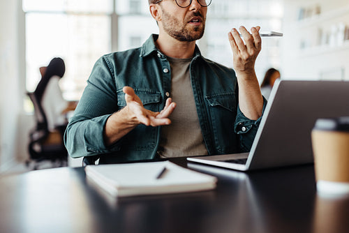 Business executive speaking on a phone call in an office