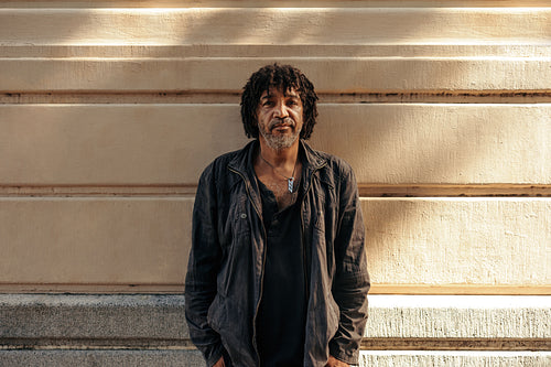 Unemployed man looking at the camera outdoors