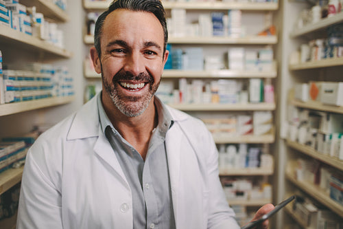 Professional male pharmacist working in medical store