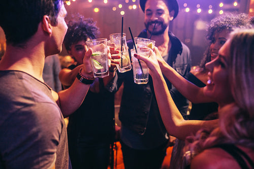 Friends at nightclub celebrating with drinks