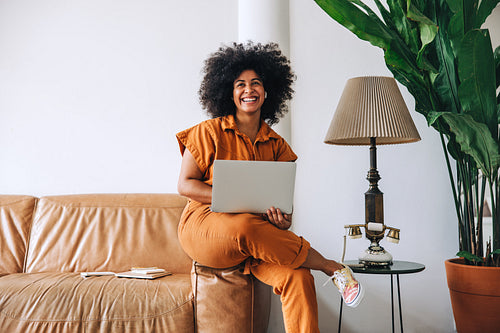 Female entrepreneur smiling happily in an office lobby