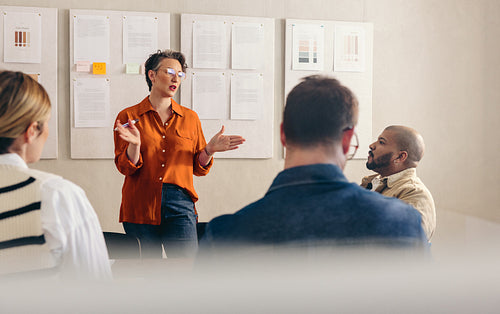 Mature busineswoman pitching her idea to her team