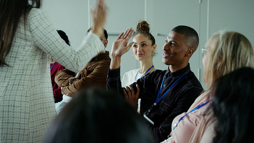 Engaged audience laughs during business presentation