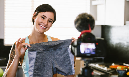 Woman making video blog on new sportswear shorts