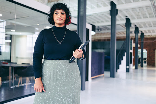 Confident businesswoman looking at the camera in a modern workplace