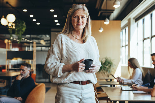 Mature businesswoman standing in a co-working space