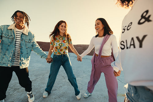 Happy group of friends in a circle enjoying a gap year adventure