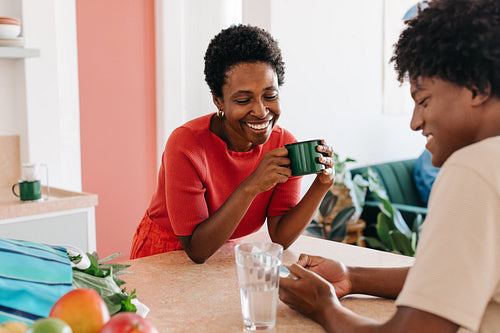 Happy mother and son enjoying morning together in authentic home kitchen