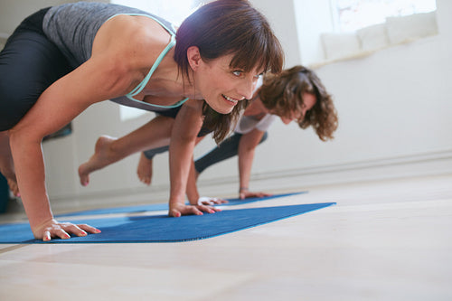 Women doing yoga handstand - Bakasana