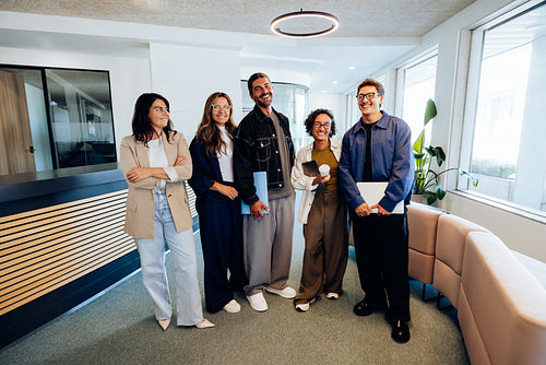 Five colleagues gather for a friendly office meet