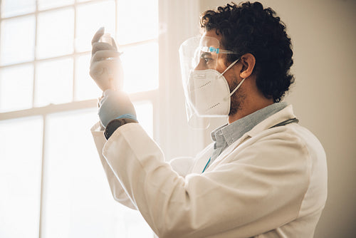 Frontline worker preparing covid-19 vaccine injection at home