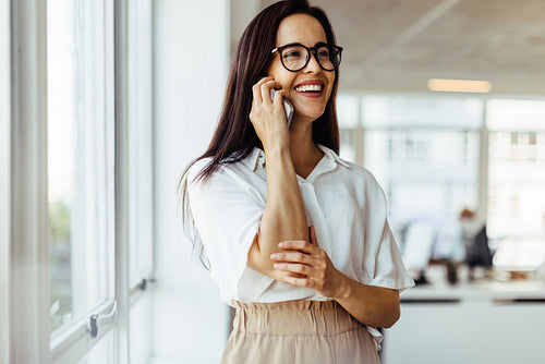 Business woman having a phone call in an office