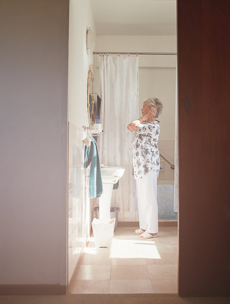 Senior female getting ready in bathroom