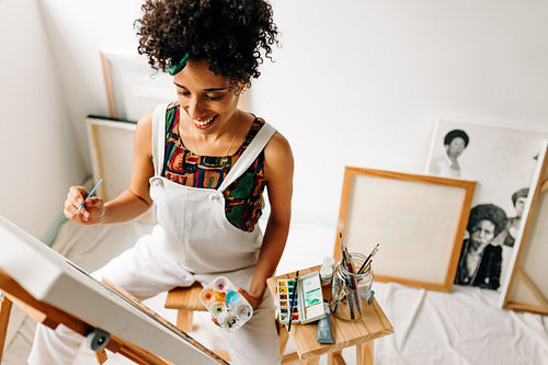 Creative young female painter working on a new painting