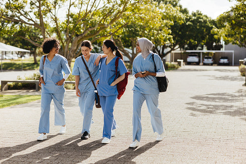 Medical school: Female health students walk to their next class at university