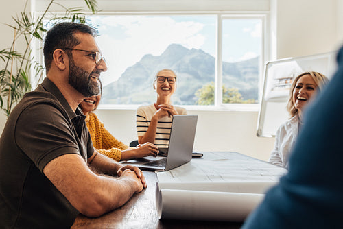 Architects brainstorming at a modern office with mountain view in daylight