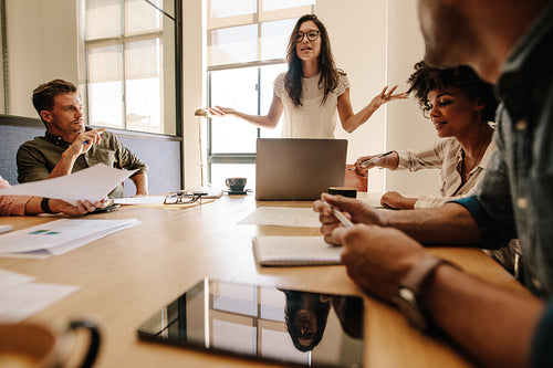 Young businesswoman giving presentation to her colleagues