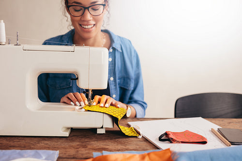 Woman sewing homemade masks at home