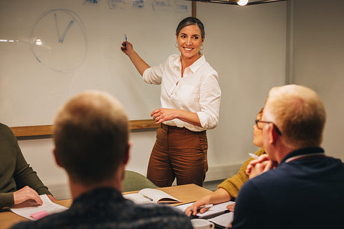 Manager giving business presentation to colleagues