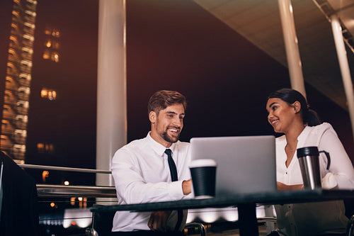 Business couple waiting for flight at airport cafe
