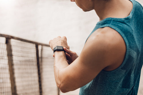 Man using fitness device to monitor his progress
