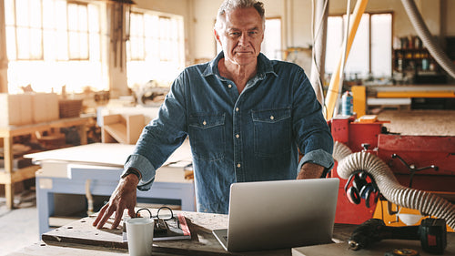 Mature male carpenter in his workshop