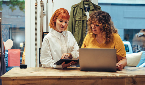 Two women running clothing store business