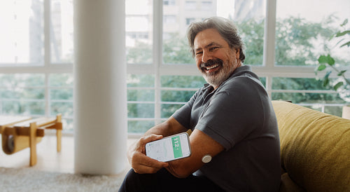 Diabetes patient reviews health data on a smartphone