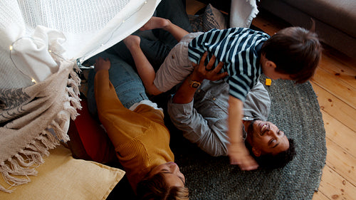 Playtime between parents and their son at home