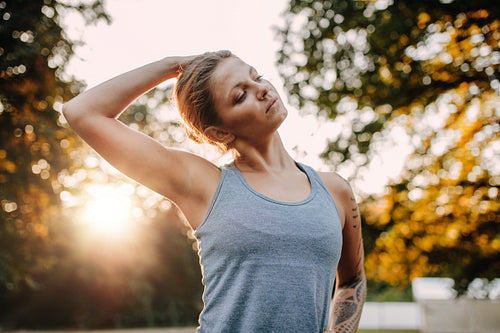 Fitness woman warming up in park