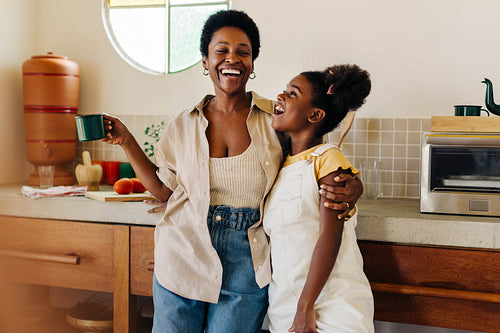 Happy mother and daughter enjoying a brazilian kitchen moment