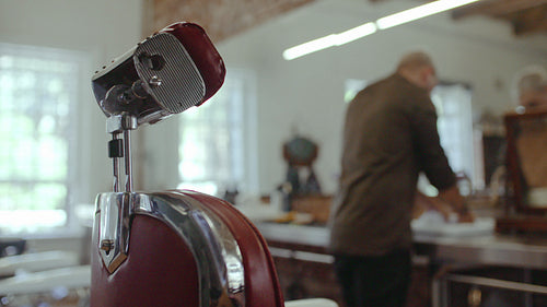 Barber preparing soaked towel for customer