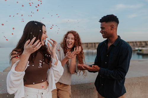 Throwing confetti party by the sea