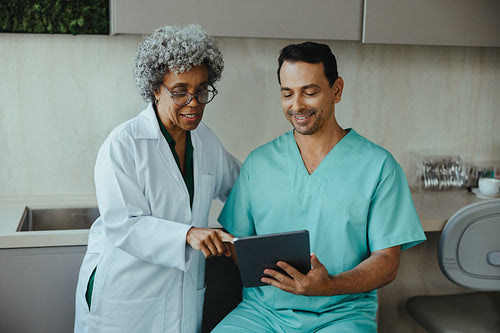 Dental professionals review case on a tablet in the clinic