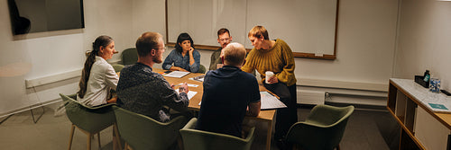 Group of corporate professionals having meeting inside boardroom