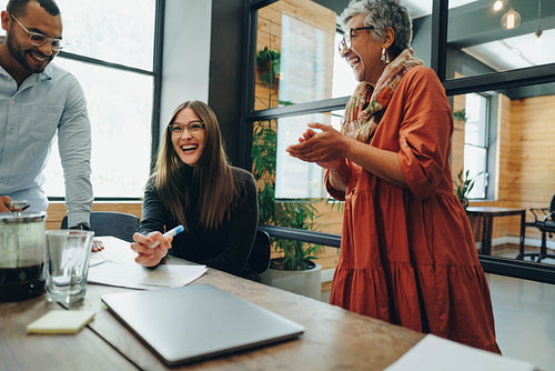 Businesspeople laughing cheerfully during a meeting