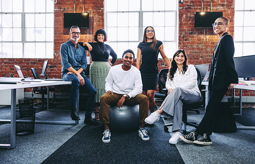 Successful businesspeople smiling at the camera in a modern offi