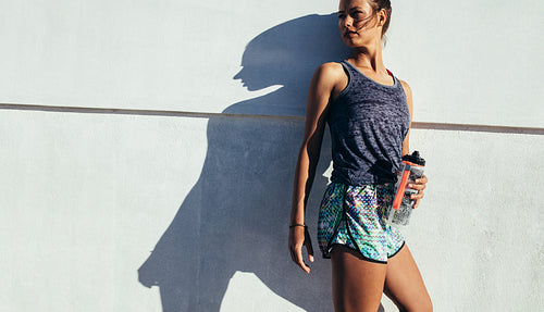 Sporty woman relaxing after running exercise