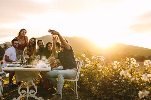 Group selfie at outdoor dinner party