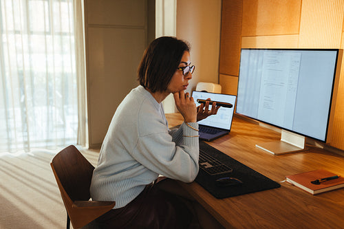 Businesswoman on phone call while working at office desk
