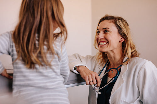 Pediatrician with girl patient at clinic