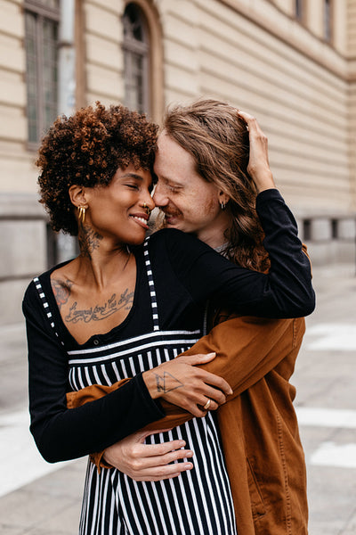 Romantic embrace on city streets with affectionate diverse couple