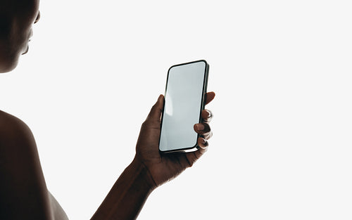 Side view of a person holding a smartphone with a blank screen