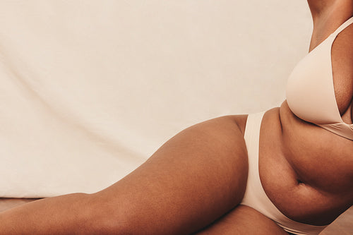 Female body wearing beige underwear