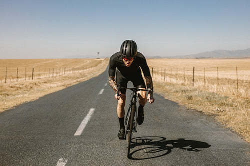 Pro bike rider cycling in countryside